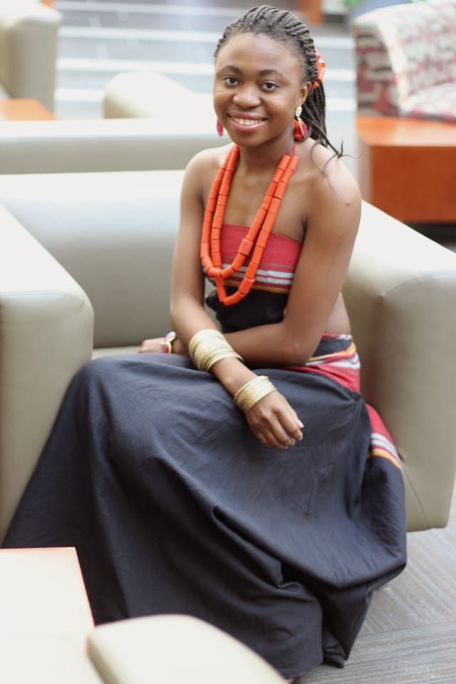 Unique Nigerian African traditional dress paired with tribal chief beads and a sleek pair of studded heels.