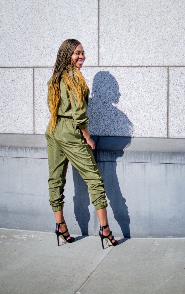 Olive Bomber Jumpsuit | Fashion blogger rocking a one-piece, long-sleeve jumpsuit paired with a multi strap sandals for a chic street style outfit. Click to check out more of her fun and affordable style.