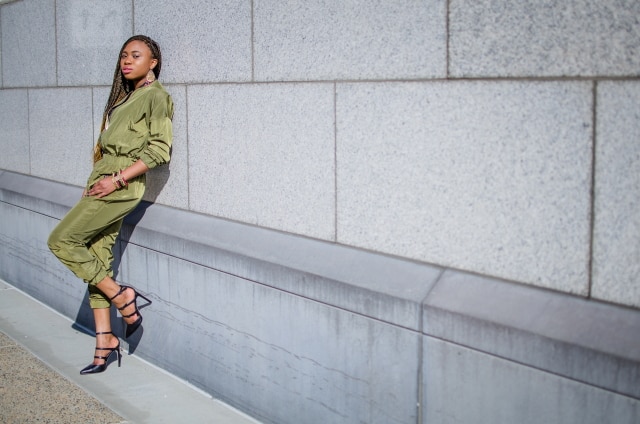 Olive Bomber Jumpsuit | Fashion blogger rocking a one-piece, long-sleeve jumpsuit paired with a multi strap sandals for a chic street style outfit. Click to check out more of her fun and affordable style.