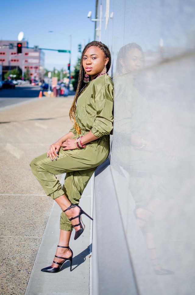 Olive Bomber Jumpsuit | Fashion blogger rocking a one-piece, long-sleeve jumpsuit paired with a multi strap sandals for a chic street style outfit. Click to check out more of her fun and affordable style.