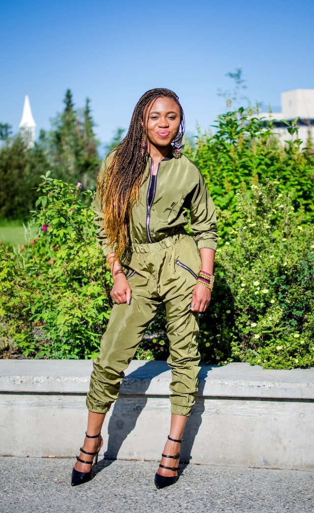 Olive Bomber Jumpsuit | Fashion blogger rocking a one-piece, long-sleeve jumpsuit paired with a multi strap sandals for a chic street style outfit. Click to check out more of her fun and affordable style.