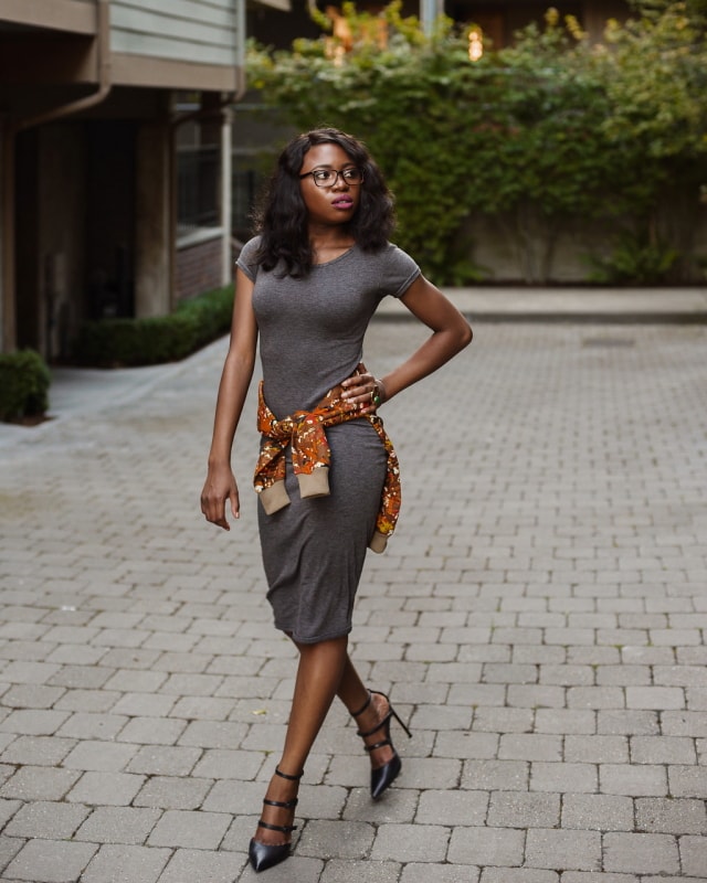 African Print Ankara Bomber Jacket | Fashion blogger styling a chic Ankara bomber jacket with a simple midi-length bodycon dress completed with black multi-strap sandals. 