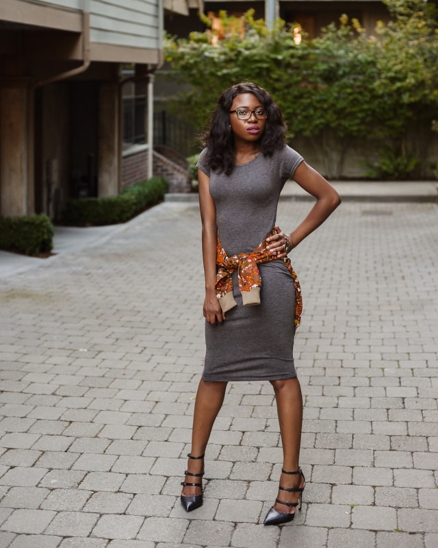 African Print Ankara Bomber Jacket | Fashion blogger styling a chic Ankara bomber jacket with a simple midi-length bodycon dress completed with black multi-strap sandals.