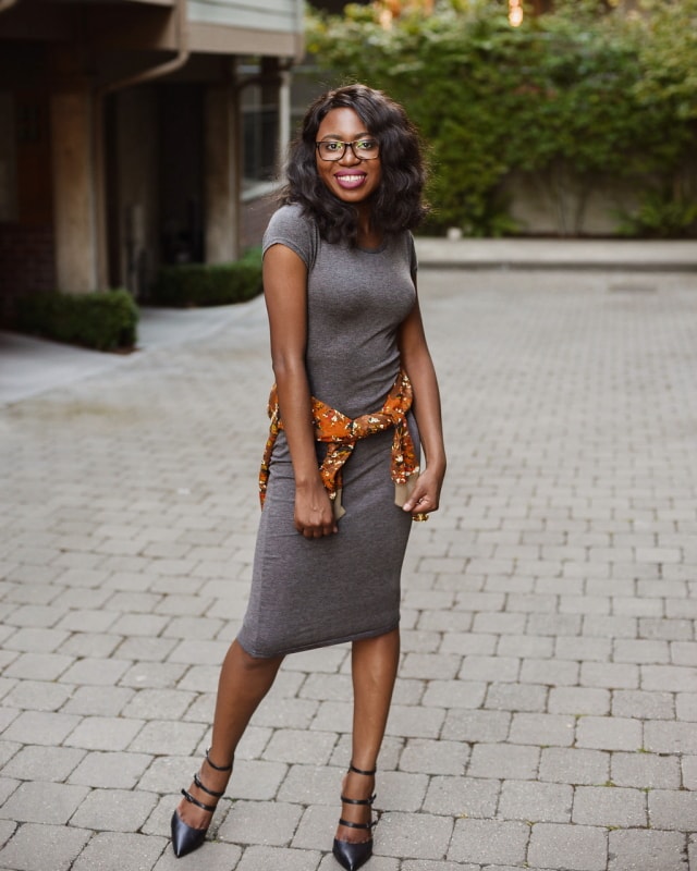 African Print Ankara Bomber Jacket | Fashion blogger styling a chic Ankara bomber jacket with a simple midi-length bodycon dress completed with black multi-strap sandals. 
