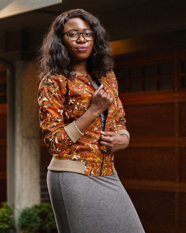 African Print Ankara Bomber Jacket | Fashion blogger styling a chic Ankara bomber jacket with a simple midi-length bodycon dress completed with black multi-strap sandals.