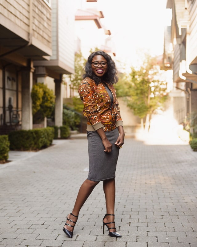 African Print Ankara Bomber Jacket | Fashion blogger styling a chic Ankara bomber jacket with a simple midi-length bodycon dress completed with black multi-strap sandals.