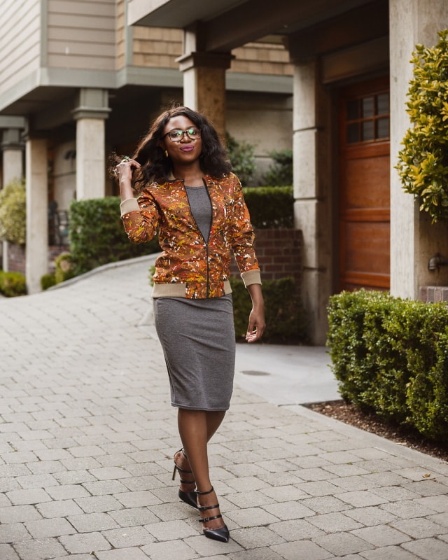 African Print Ankara Bomber Jacket | Fashion blogger styling a chic Ankara bomber jacket with a simple midi-length bodycon dress completed with black multi-strap sandals.