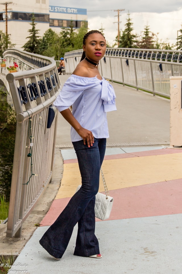 A super cute summer outfit wearing a wide leg flare jeans and a stylish off the shoulder faux sleeve top. Visit the blog for the complete look.