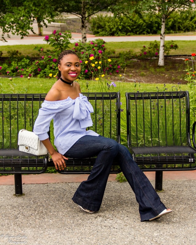 A super cute summer outfit wearing a wide leg flare jeans and a stylish off the shoulder faux sleeve top. Visit the blog for the complete look.