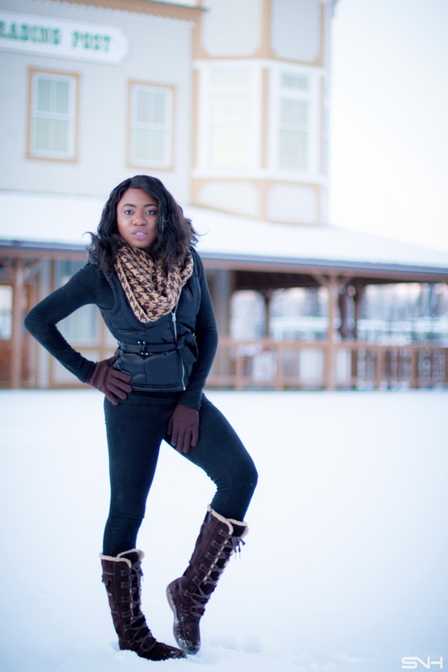 Winter fashion outfit idea wearing a sleeveless winter vest, waterproof insulated winter boots, and Cuddl Duds fleecewear pants, and infinity scarf