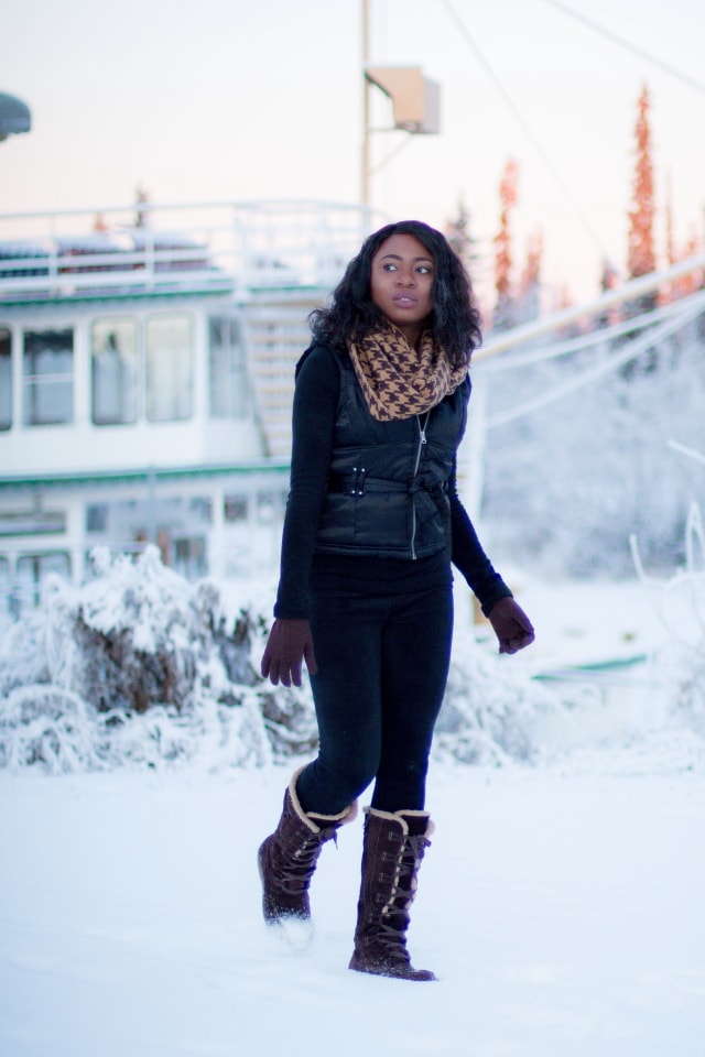 Winter fashion outfit idea wearing a sleeveless winter vest, waterproof insulated winter boots, and Cuddl Duds fleecewear pants, and infinity scarf