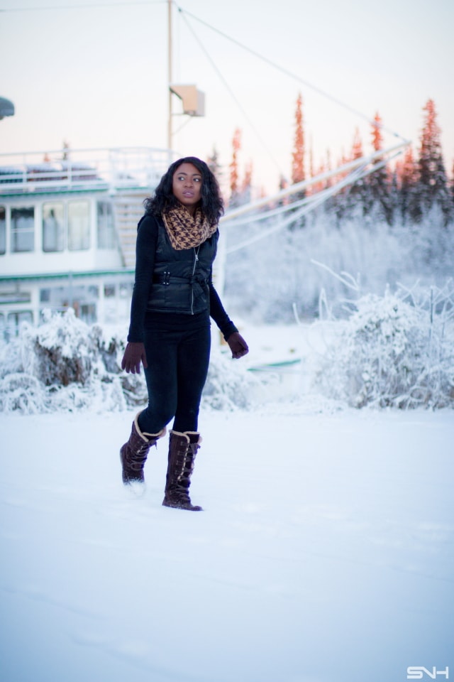 Winter fashion outfit idea wearing a sleeveless winter vest, waterproof insulated winter boots, and Cuddl Duds fleecewear pants, and infinity scarf