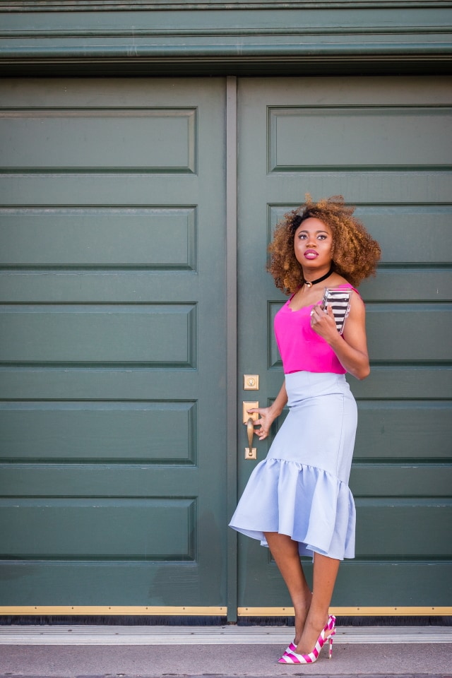 Peplum skirt and scallop edge tops are summer style must-haves. I'm obsessed with the contrast between the bright pink sleeveless top and pastel blue skirt. The striped heels and box clutch are the perfect accessories too. | Summer fashion | Fashion blogger | Spring style | Spring outfit | Black blogger | Spring fashion | Summer looks | Summer hair | Street Style |