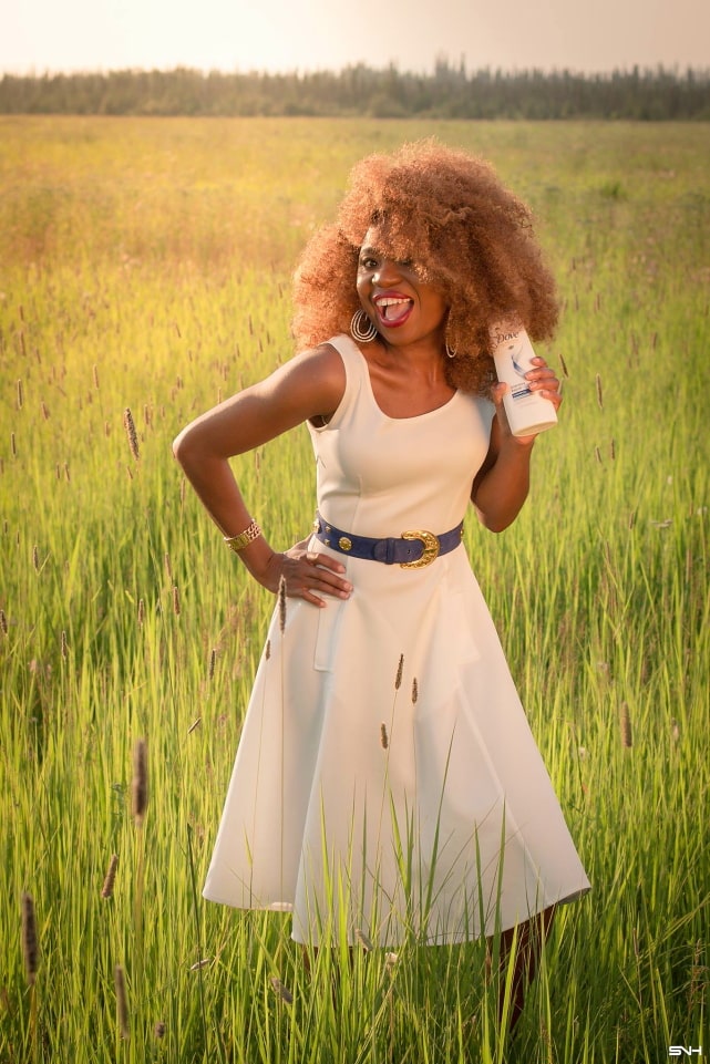 Can't get over her stunning white summer dress! ? Twirling in the prairie fields. Her sleeveless A-line midi dress has the perfect flare. Bold statement hoop earrings and embellished blue belt perfects her outfit. A dress that you can dress up or down! Dove Intensive Repair, Little white dress, flare dress, Dress with flare, Summer dress, Formal dress, Modest dress, Wedding guest outfit, Black girl, Classy dress, womens style #WashRepairRepeat #CLVR #ad