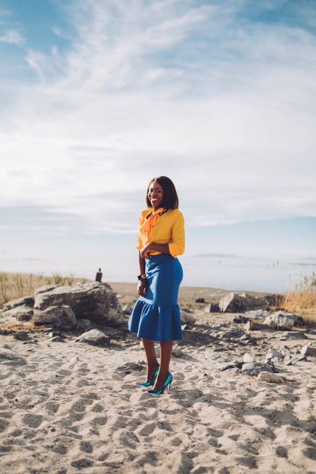 Never thought blue & yellow would look this good! Very work appropriate and stylish with the neck tie bow and peplum midi skirt. ?? Work style, dressy outfit, women's style, black girl, Nigerian blogger, pussy bow top, neoprene skirt, iridescent hologram heels