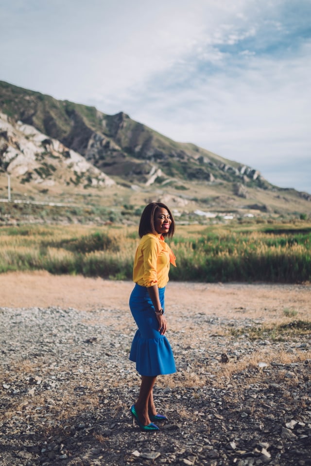 Never thought blue & yellow would look this good! Very work appropriate and stylish with the neck tie bow and peplum midi skirt. ?? Work style, dressy outfit, women's style, black girl, Nigerian blogger, pussy bow top, neoprene skirt, iridescent hologram heels