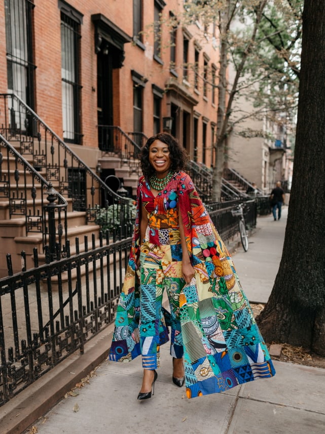 How I love the dramatic cape sleeves of this rainbow patchwork ankara jumpsuit. I'm sure she turned heads when she showed up to New York Fashion Week dressed like this. With simple wavy hair, black pumps and green statement necklace to match, it'll be no surprise if the media swoons over her. Stunning NYFW Fall/Winter 2017 outfit #NYFW #NewYorkFashionWeek #Ankara #Kente