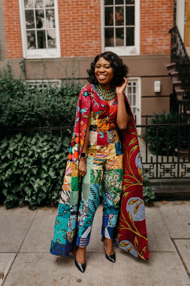 How I love the dramatic cape sleeves of this rainbow patchwork ankara jumpsuit. I'm sure she turned heads when she showed up to New York Fashion Week dressed like this. With simple wavy hair, black pumps and green statement necklace to match, it'll be no surprise if the media swoons over her. Stunning New York Fashion Week Fall/Winter 2017 outfit #NYFW #ootd #Ankara #Kente