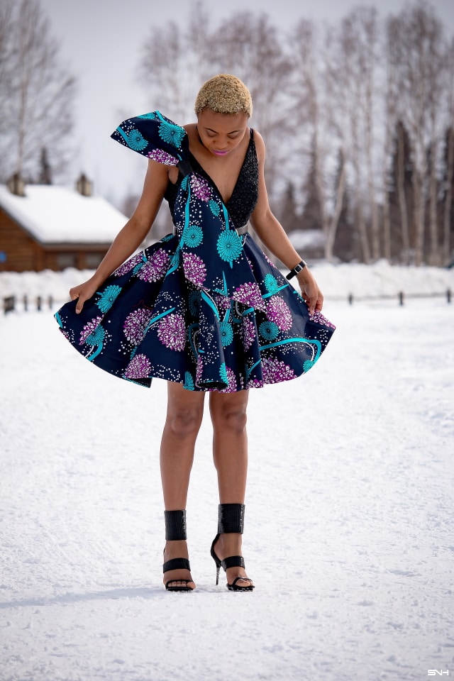 Millennial fashion and beauty blogger, Louisa takes us on an epic fashion series showcasing some of the most spectacular, wearable African print styles we've ever seen! Case in point, this elaborate African print cocktail dress made with premium ankara fabric mixed with a sequin V neck fabric and an exposed back. And oh, she makes winter in Alaska look so balmy! Dashiki, African print dress, African fashion, African women dresses, African prints, Nigerian style, Nigerian fashion