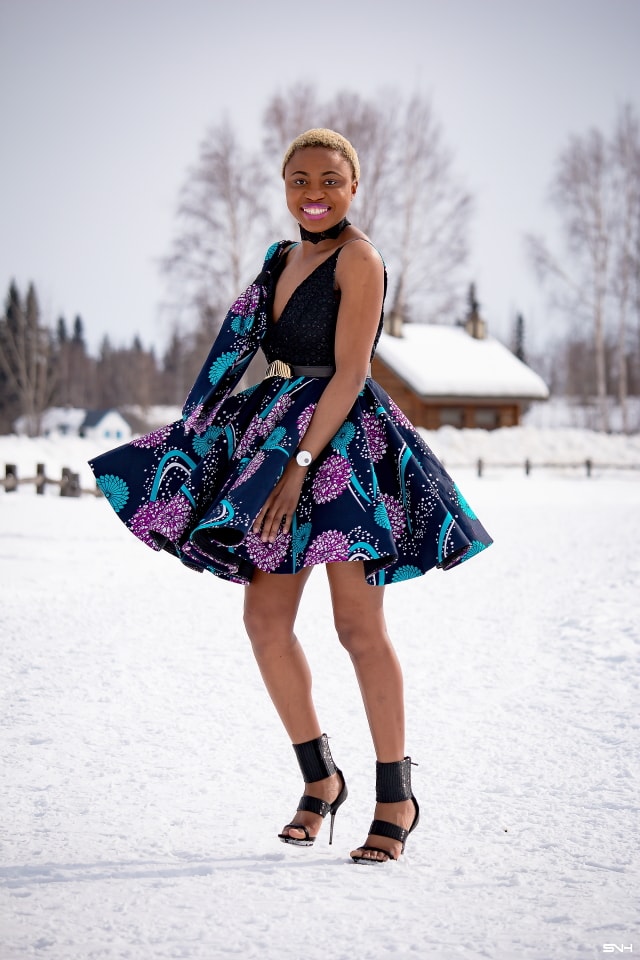 Millennial fashion and beauty blogger, Louisa takes us on an epic fashion series showcasing some of the most spectacular, wearable African print styles we've ever seen! Case in point, this elaborate African print cocktail dress made with premium ankara fabric mixed with a sequin V neck fabric and an exposed back. And oh, she makes winter in Alaska look so balmy! Dashiki, African print dress, African fashion, African women dresses, African prints, Nigerian style, Nigerian fashion