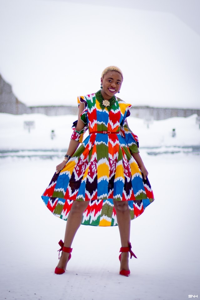 Louisa Moje is a Nigerian fashion blogger who runs La Passion Voutee. Her refined style, vibrant and elegant African print outfits invite you on a colorful and artist journey. Her ankara fashion series like this African print high-low dress featuring African print designers around the world has been a hit. The way she gracefully showcases these beautiful prints against the Alaska snow make her looks stand out. #ankara #africanprint #ankarafashion #nigerian