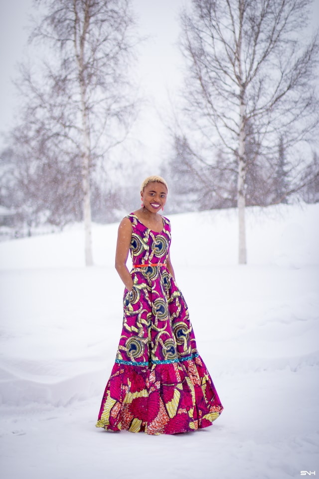 This African wax print maxi dress has me has me oohing and ahhing about ankara styles and summer dresses. Style blogger, Louisa serves major major hotness in this jawdropping ankara dress as part of a 20+ days of African print fashion. The perfect dress to rock to a balmy summer wedding. This outfit from Day 13 of the series is by With Flare Designs. The pops of pink, blue and orange sine beautifully in the background. #africanprint #ankara #ankarafashion #kente