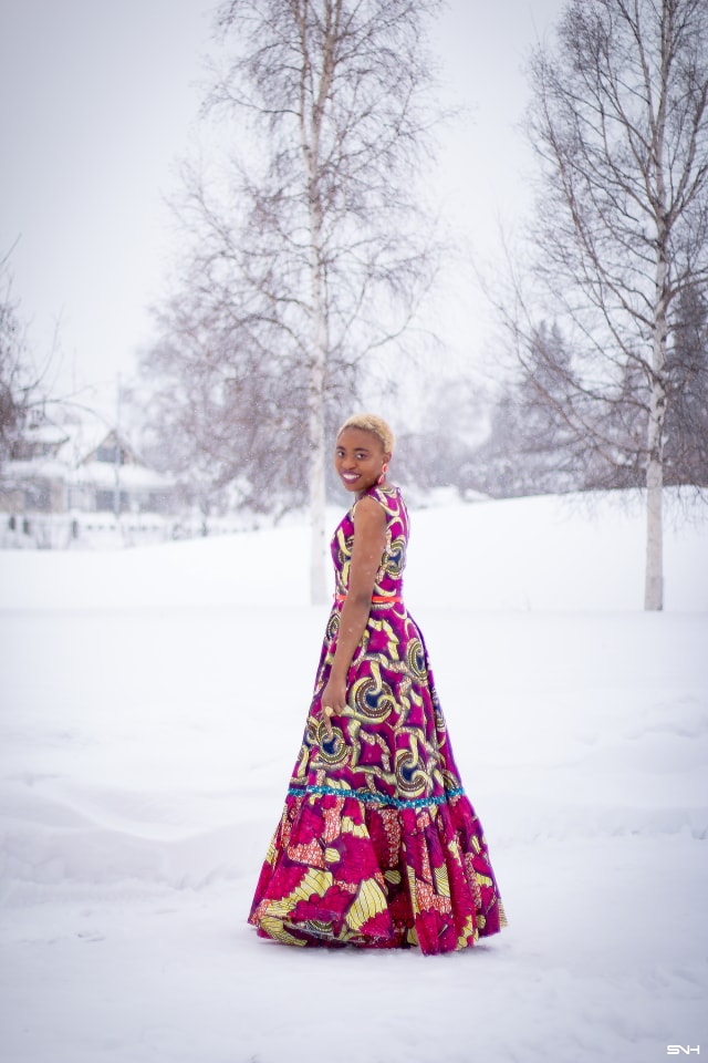 This African wax print maxi dress has me has me oohing and ahhing about ankara styles and summer dresses. Style blogger, Louisa serves major major hotness in this jawdropping ankara dress as part of a 20+ days of African print fashion. The perfect dress to rock to a balmy summer wedding. This outfit from Day 13 of the series is by With Flare Designs. The pops of pink, blue and orange sine beautifully in the background. #africanprint #ankara #ankarafashion #kente