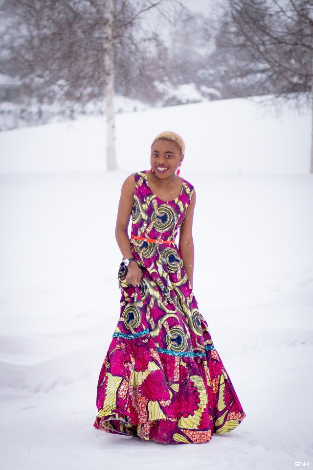 This African wax print maxi dress has me has me oohing and ahhing about ankara styles and summer dresses. Style blogger, Louisa serves major major hotness in this jawdropping ankara dress as part of a 20+ days of African print fashion. The perfect dress to rock to a balmy summer wedding. This outfit from Day 13 of the series is by With Flare Designs. The pops of pink, blue and orange sine beautifully in the background. #africanprint #ankara #ankarafashion #kente