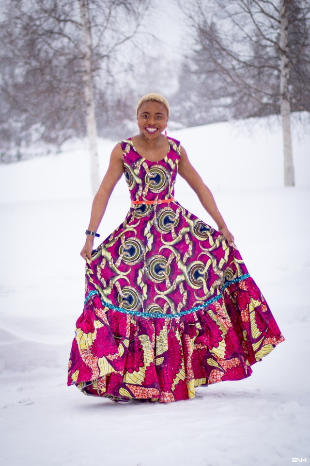 This African wax print maxi dress has me has me oohing and ahhing about ankara styles and summer dresses. Style blogger, Louisa serves major major hotness in this jawdropping ankara dress as part of a 20+ days of African print fashion. The perfect dress to rock to a balmy summer wedding. This outfit from Day 13 of the series is by With Flare Designs. The pops of pink, blue and orange sine beautifully in the background. #africanprint #ankara #ankarafashion #kente