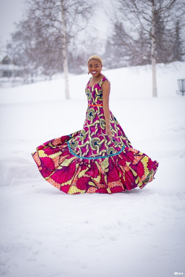 This African wax print maxi dress has me has me oohing and ahhing about ankara styles and summer dresses. Style blogger, Louisa serves major major hotness in this jawdropping ankara dress as part of a 20+ days of African print fashion. The perfect dress to rock to a balmy summer wedding. This outfit from Day 13 of the series is by With Flare Designs. The pops of pink, blue and orange sine beautifully in the background. #africanprint #ankara #ankarafashion #kente