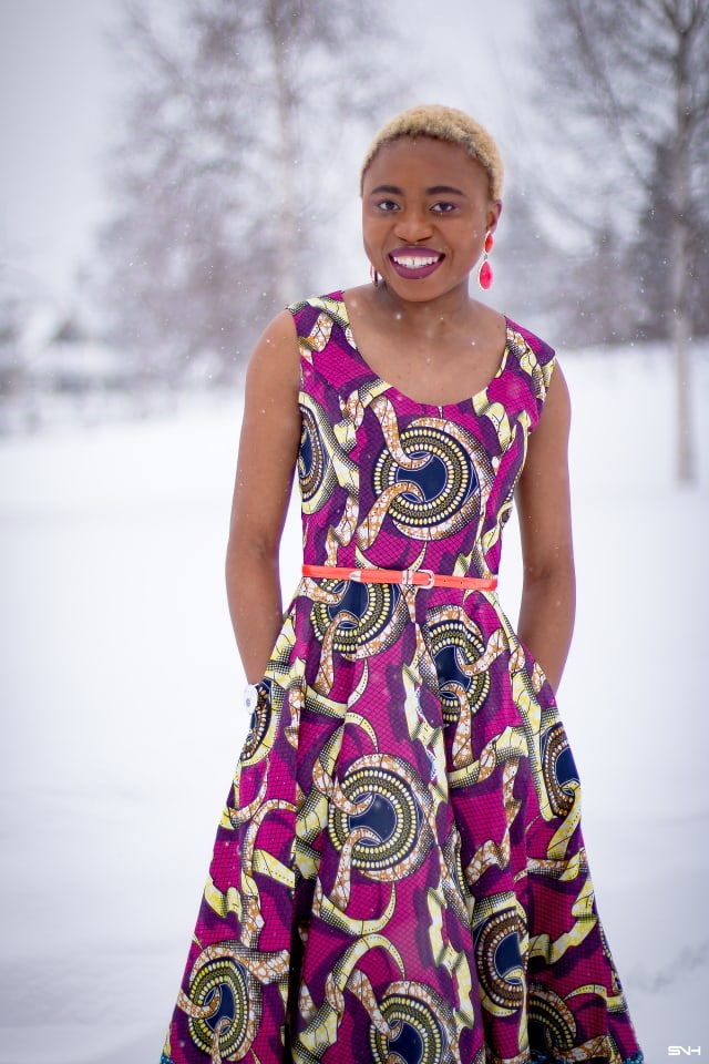 This African wax print maxi dress has me has me oohing and ahhing about ankara styles and summer dresses. Style blogger, Louisa serves major major hotness in this jawdropping ankara dress as part of a 20+ days of African print fashion. The perfect dress to rock to a balmy summer wedding. This outfit from Day 13 of the series is by With Flare Designs. The pops of pink, blue and orange sine beautifully in the background. #africanprint #ankara #ankarafashion #kente