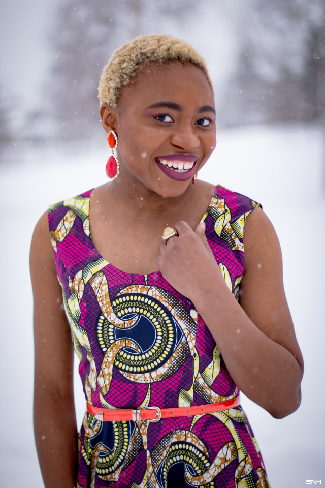 This African wax print maxi dress has me has me oohing and ahhing about ankara styles and summer dresses. Style blogger, Louisa serves major major hotness in this jawdropping ankara dress as part of a 20+ days of African print fashion. The perfect dress to rock to a balmy summer wedding. This outfit from Day 13 of the series is by With Flare Designs. The pops of pink, blue and orange sine beautifully in the background. #africanprint #ankara #ankarafashion #kente