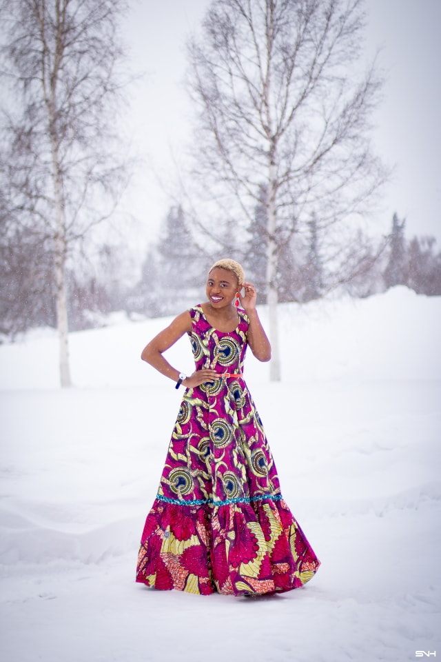 This African wax print maxi dress has me has me oohing and ahhing about ankara styles and summer dresses. Style blogger, Louisa serves major major hotness in this jawdropping ankara dress as part of a 20+ days of African print fashion. The perfect dress to rock to a balmy summer wedding. This outfit from Day 13 of the series is by With Flare Designs. The pops of pink, blue and orange sine beautifully in the background. #africanprint #ankara #ankarafashion #kente