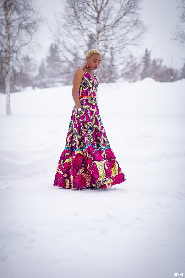 This African wax print maxi dress has me has me oohing and ahhing about ankara styles and summer dresses. Style blogger, Louisa serves major major hotness in this jawdropping ankara dress as part of a 20+ days of African print fashion. The perfect dress to rock to a balmy summer wedding. This outfit from Day 13 of the series is by With Flare Designs. The pops of pink, blue and orange sine beautifully in the background. #africanprint #ankara #ankarafashion #kente