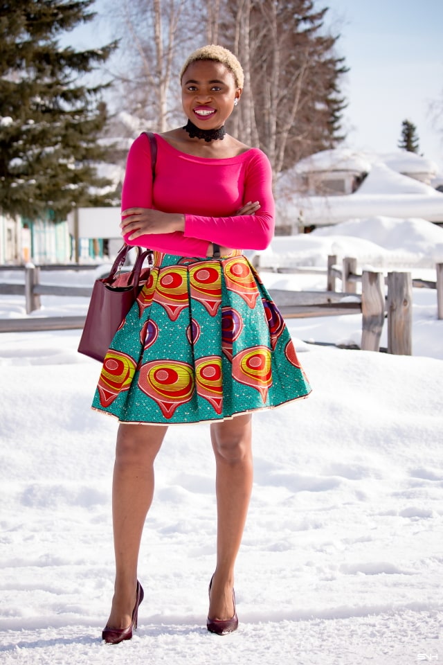 Day 22: Preppy Ankara Printed Skirt | Everyday style for the fashionable woman. Nigerian style blogger takes us on an epic ride wearing the most enviable African print clothes for 30 days. Check out how she paired this signature preppy ankara printed skirt with a modern touch of a boat neck / off the shoulder top. The burgundy bucket purse and matching heels seals this look to perfection! #africanprint #ankara #fashionblogger