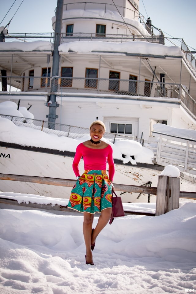 Day 22: Preppy Ankara Printed Skirt | Everyday style for the fashionable woman. Nigerian style blogger takes us on an epic ride wearing the most enviable African print clothes for 30 days. Check out how she paired this signature preppy ankara printed skirt with a modern touch of a boat neck / off the shoulder top. The burgundy bucket purse and matching heels seals this look to perfection! #africanprint #ankara #fashionblogger