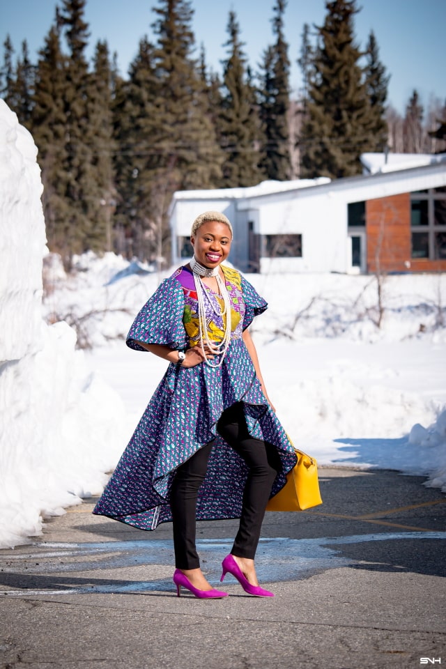 To say that African print clothes are fascinating is an understatement. This tiered African print high low top is the perfect statement blouse this summer. The rich purple, yellow and blue colors paired with fitted black denim and a vibrant satchel is a winner. Can't get enough! Check out this blogger's 30 days of African print fashion! #ankara #africanprint #ankarafashion #nigerian Dashiki, African print dress, African fashion, African women dresses, African prints, Nigerian style