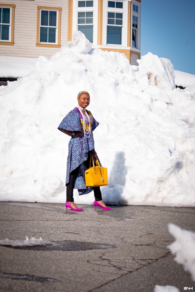 To say that African print clothes are fascinating is an understatement. This tiered African print high low top is the perfect statement blouse this summer. The rich purple, yellow and blue colors paired with fitted black denim and a vibrant satchel is a winner. Can't get enough! Check out this blogger's 30 days of African print fashion! #ankara #africanprint #ankarafashion #nigerian Dashiki, African print dress, African fashion, African women dresses, African prints, Nigerian style