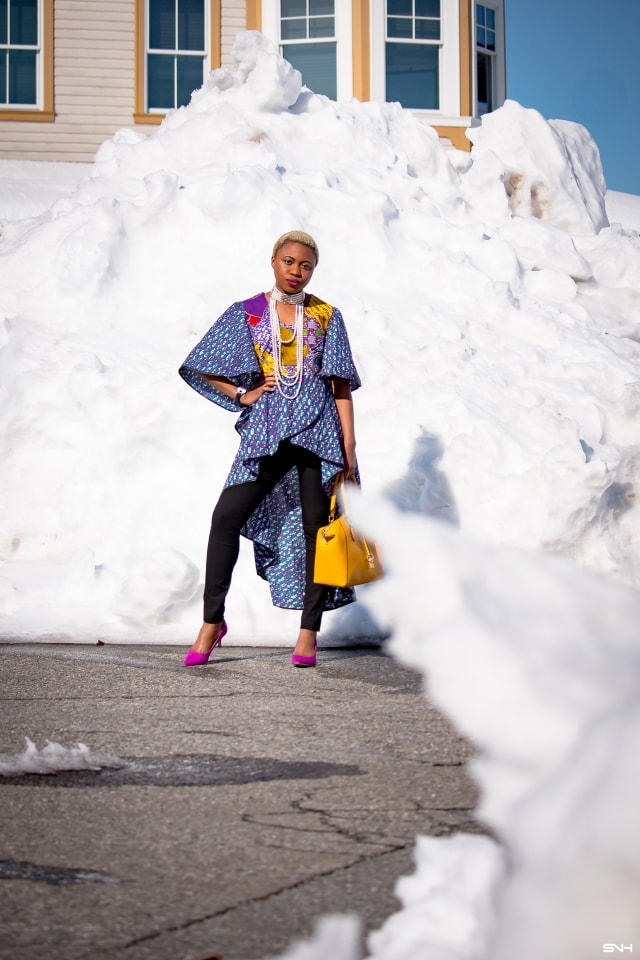 To say that African print clothes are fascinating is an understatement. This tiered African print high low top is the perfect statement blouse this summer. The rich purple, yellow and blue colors paired with fitted black denim and a vibrant satchel is a winner. Can't get enough! Check out this blogger's 30 days of African print fashion! #ankara #africanprint #ankarafashion #nigerian Dashiki, African print dress, African fashion, African women dresses, African prints, Nigerian style