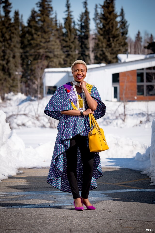 To say that African print clothes are fascinating is an understatement. This tiered African print high low top is the perfect statement blouse this summer. The rich purple, yellow and blue colors paired with fitted black denim and a vibrant satchel is a winner. Can't get enough! Check out this blogger's 30 days of African print fashion! #ankara #africanprint #ankarafashion #nigerian Dashiki, African print dress, African fashion, African women dresses, African prints, Nigerian style