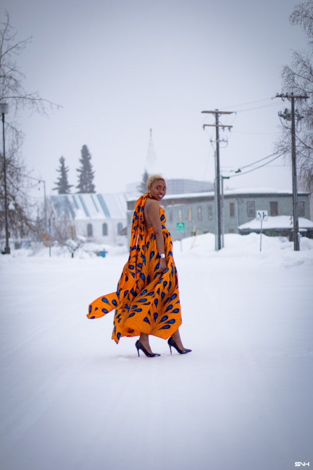 OMG where can I get this jaw-dropping ankara print dress? I need African print dresses like this multiway wax print dress that can be worn in multiple ways. And the way Louisa styled this dress as part of her 30 days of African outfits has me drooling. Such a unique contrast wearing a summer dress in the heart of winter! #africanprint #ankarafashion African prints, Nigerian fashion, African fashion, African print dresses, African dresses