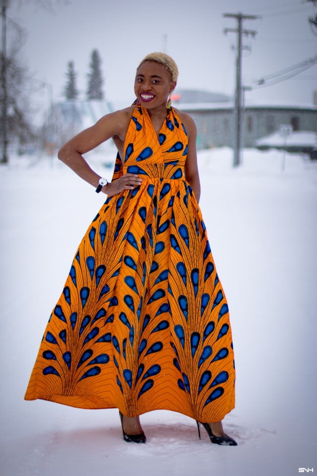 OMG where can I get this jaw-dropping ankara print dress? I need African print dresses like this multiway wax print dress that can be worn in multiple ways. And the way Louisa styled this dress as part of her 30 days of African outfits has me drooling. Such a unique contrast wearing a summer dress in the heart of winter! #africanprint #ankarafashion African prints, Nigerian fashion, African fashion, African print dresses, African dresses