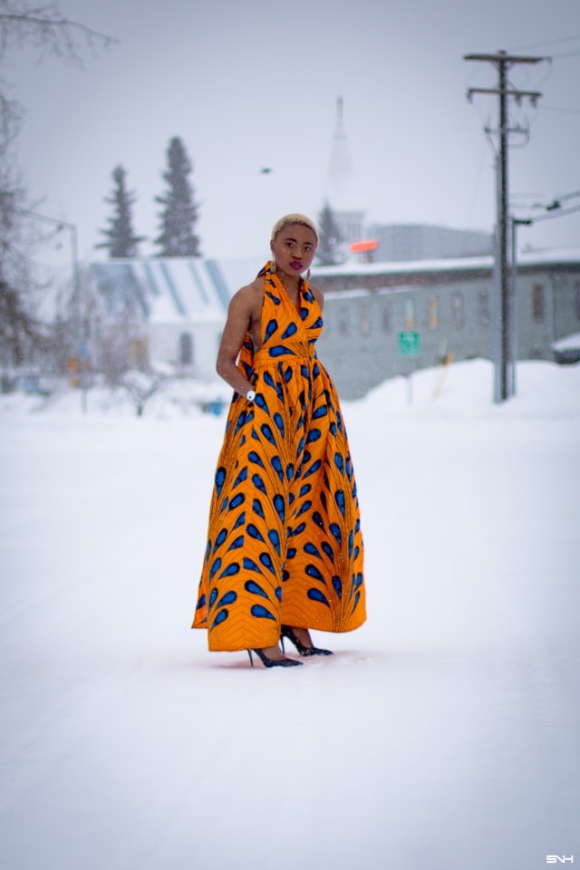 OMG where can I get this jaw-dropping ankara print dress? I need African print dresses like this multiway wax print dress that can be worn in multiple ways. And the way Louisa styled this dress as part of her 30 days of African outfits has me drooling. Such a unique contrast wearing a summer dress in the heart of winter! #africanprint #ankarafashion African prints, Nigerian fashion, African fashion, African print dresses, African dresses