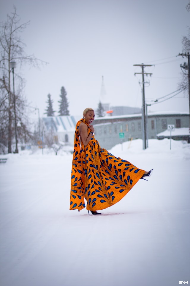 OMG where can I get this jaw-dropping ankara print dress? I need African print dresses like this multiway wax print dress that can be worn in multiple ways. And the way Louisa styled this dress as part of her 30 days of African outfits has me drooling. Such a unique contrast wearing a summer dress in the heart of winter! #africanprint #ankarafashion African prints, Nigerian fashion, African fashion, African print dresses, African dresses