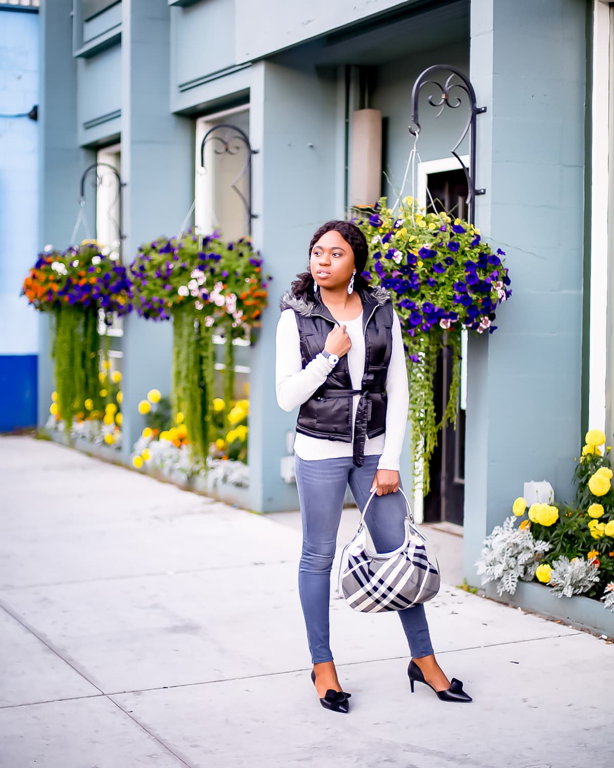 Totally crushing on the contrasting shades of this gray and black sweater outfit. The marriage between the black puffy vest is a welcome contrast against a gray ruffle sweater and dark gray mid-rise Old Navy Rockstar jeans. The outfit is tied together with a pair of cute kitten heels d’orsay pumps with contrasting suede and leather bows. Alaska fashion blogger, Old Navy Rockstar jeans review, grey sweater outfit, cute fall outfit, New Jersey fashion blogger, kitten heels