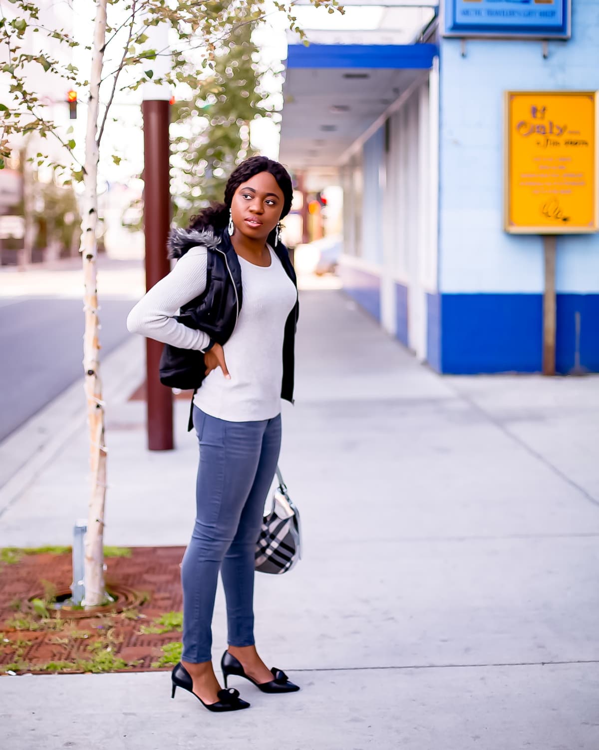 Totally crushing on the contrasting shades of this gray and black sweater outfit. The marriage between the black puffy vest is a welcome contrast against a gray ruffle sweater and dark gray mid-rise Old Navy Rockstar jeans. The outfit is tied together with a pair of cute kitten heels d’orsay pumps with contrasting suede and leather bows. Alaska fashion blogger, Old Navy Rockstar jeans review, grey sweater outfit, cute fall outfit, New Jersey fashion blogger, kitten heels