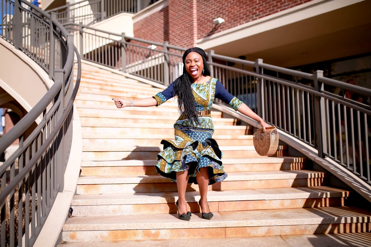 Looking for the best African midi dress for a special occasion? You’ll love this stylish and magnificent African print out. This Nigerian fashion blogger shows two ways to style an ankara dress with high bow pumps, metallic belt and the prettiest under $40 wooden bamboo handbag. Plus details on where to get the exact dress or make one for yourself. All about how to wear African fashion dresses and African clothing. #nigerianfashion #summeroutfits #womensafricanfashion