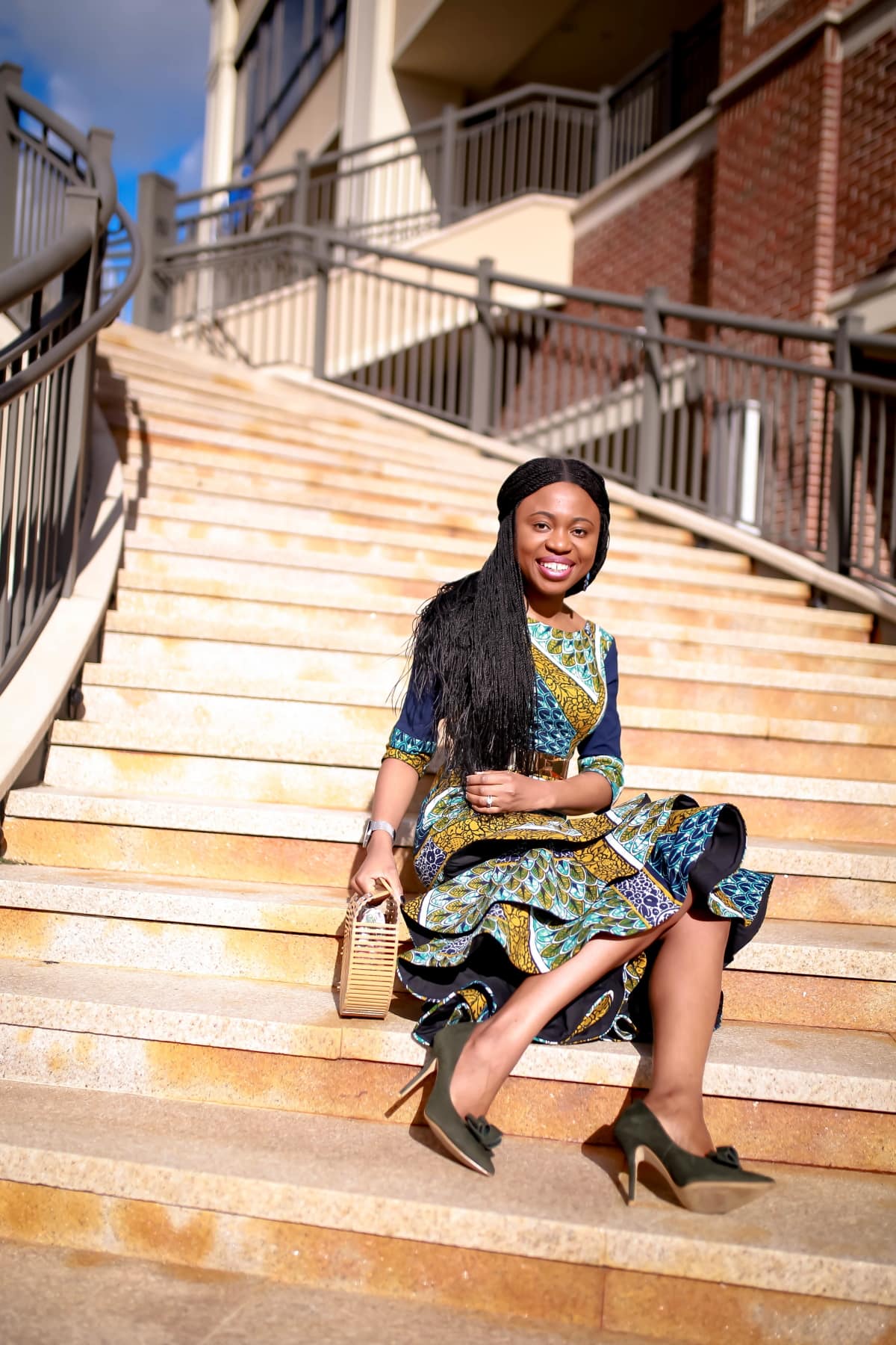 Looking for the perfect African print dress this summer? Ankara dress lover, Louisa, shares how she styles this lovely African attire, a three-tier ankara peplum dress in two ways. Plus details on where to buy the exact ankara midi dress she is wearing and how to make this African fashion dress for yourself. All about #africanfashionoutfits #africanprint #africanfashionstyles #nigerianfashion.