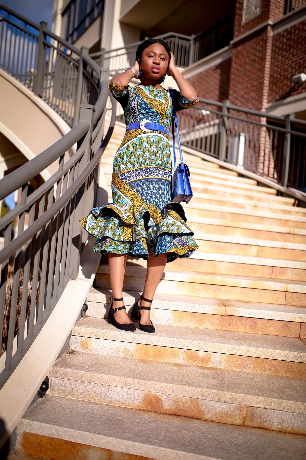 Looking for the perfect African print dress this summer? Ankara dress lover, Louisa, shares how she styles this lovely African attire, a three-tier ankara peplum dress in two ways. Plus details on where to buy the exact ankara midi dress she is wearing and how to make this African fashion dress for yourself. All about #africanfashionoutfits #africanprint #africanfashionstyles #nigerianfashion.