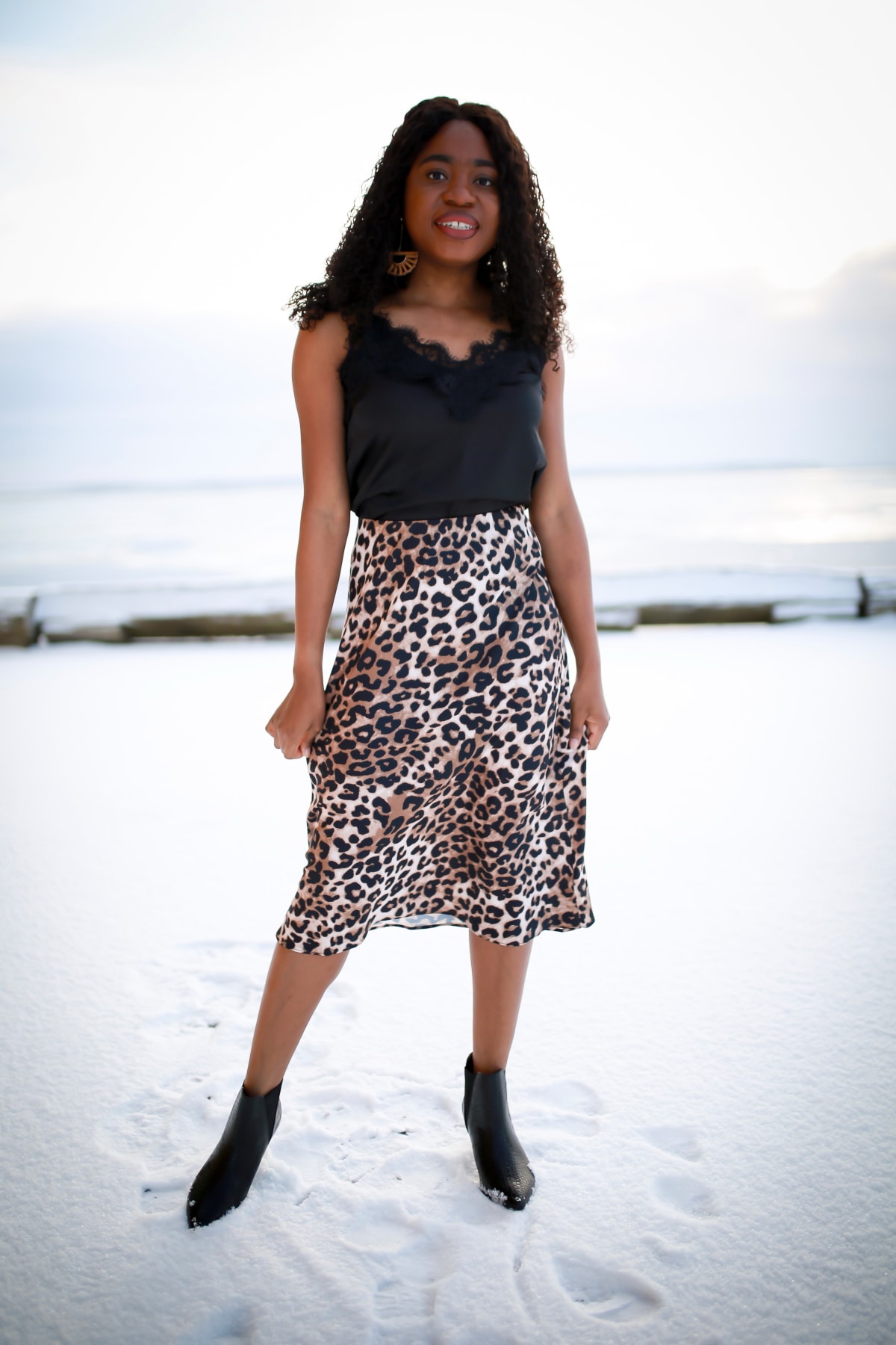 Crushing on this stylish leopard print outfit paired a chic lace-trimmed cami with a timeless animal print midi skirt and croco-embossed kitten heeled boots. Definitely, the perfect way to add a sensual touch to your outfit.